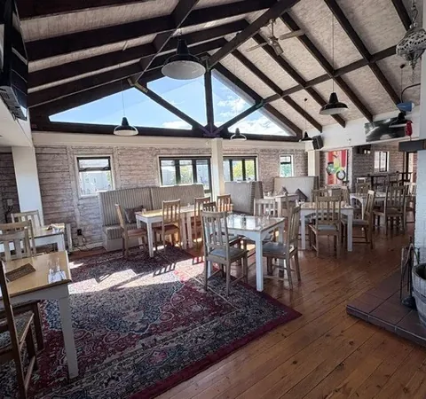 Sunlit timber-beamed dining room