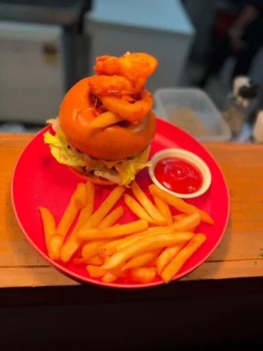 Burger with onion rings and a side of fries