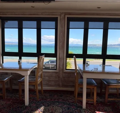 Window-side tables looking across Lake Taupō