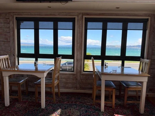 A table next to the windows overlooking Lake Taupō